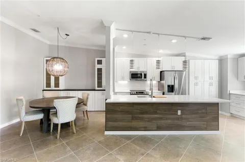 a kitchen with refrigerator and cabinets