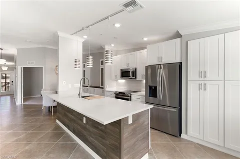 a kitchen with refrigerator and window
