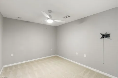 an empty room with windows and closet