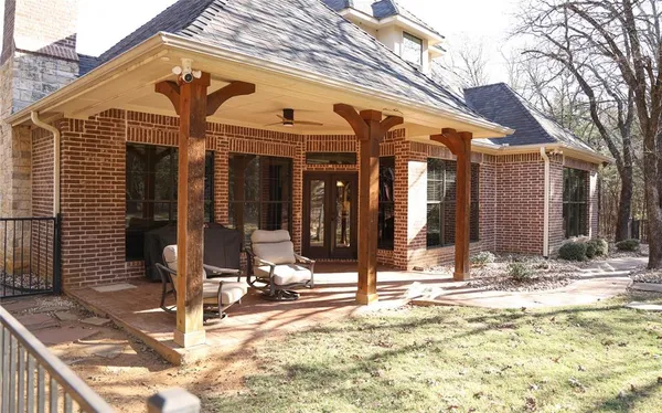 a view of a porch with a table and chairs