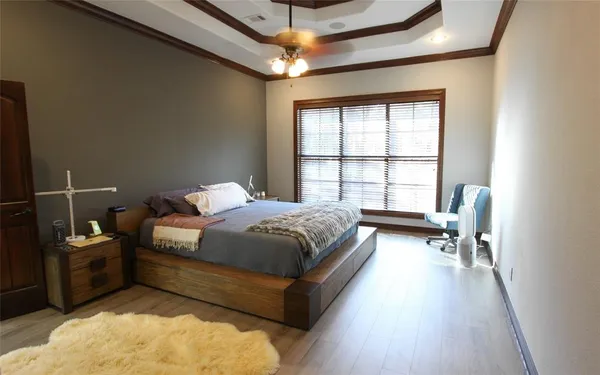 a spacious bedroom with a bed and window