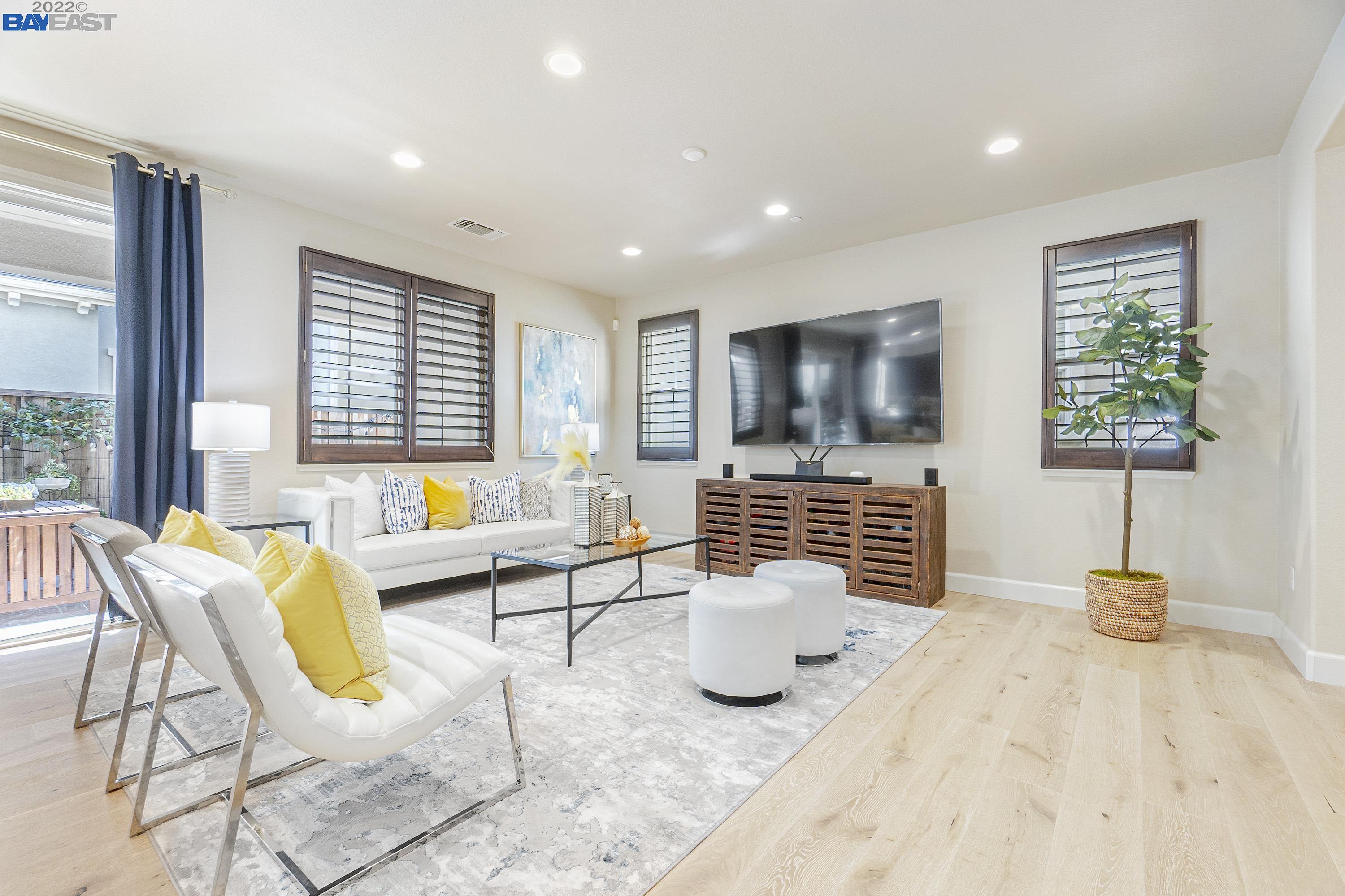 a bedroom with furniture and a flat screen tv