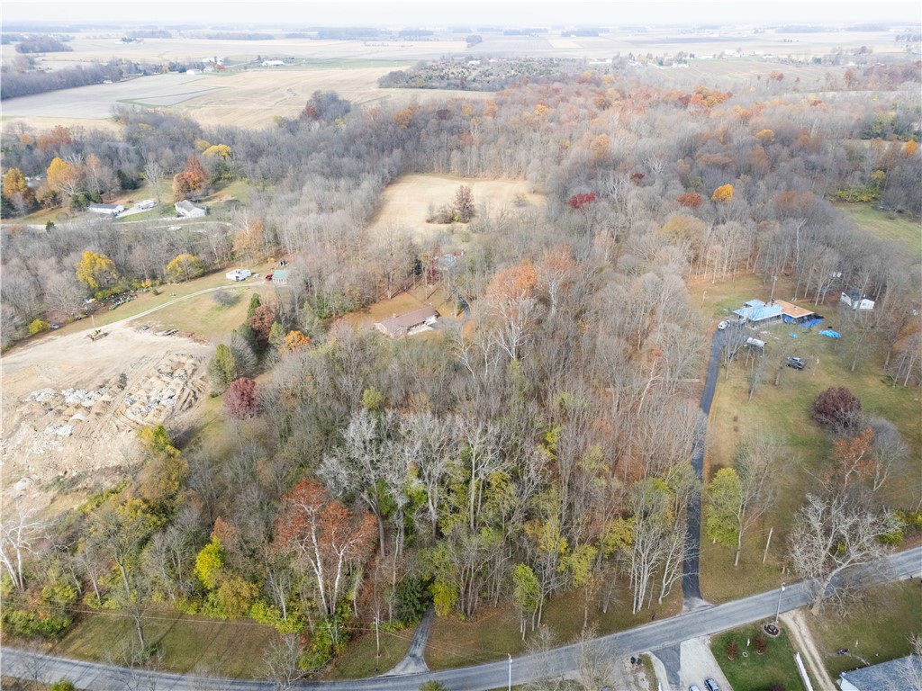 18333 Lefevre Number 2 Road Sidney, OH 45365 - Photo 14 of 25 This expansive property offers a private, natural setting with lush greenery and ample space for outdoor pursuits.