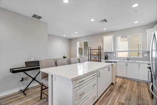 a large white kitchen with a large window