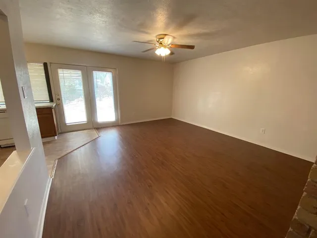 wooden floor in an empty room with a window