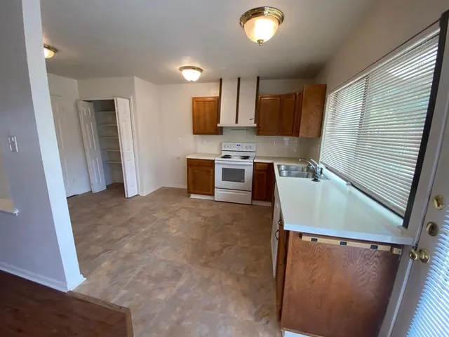 a kitchen with a refrigerator and a stove top oven