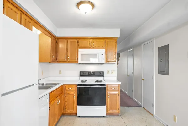 a kitchen with stainless steel appliances a stove a sink and a microwave