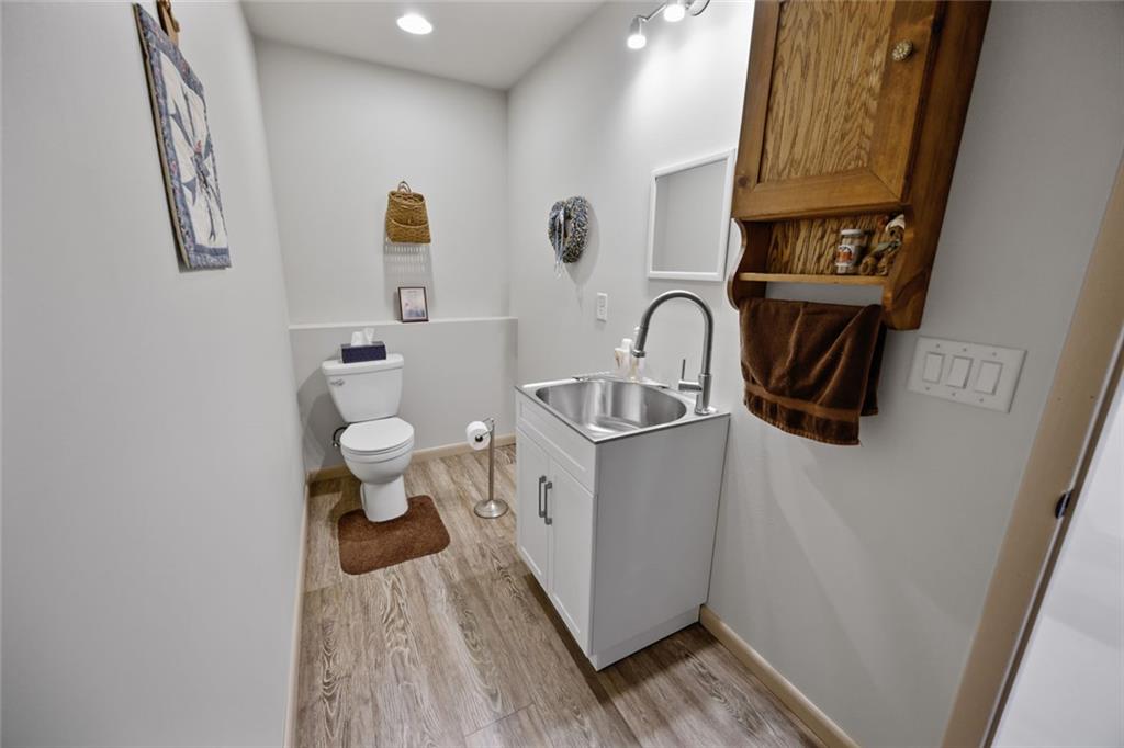 1581 Taylor Town Road Northeast Ranger, GA 30734 - Photo 20 of 30 a bathroom with a toilet sink and mirror