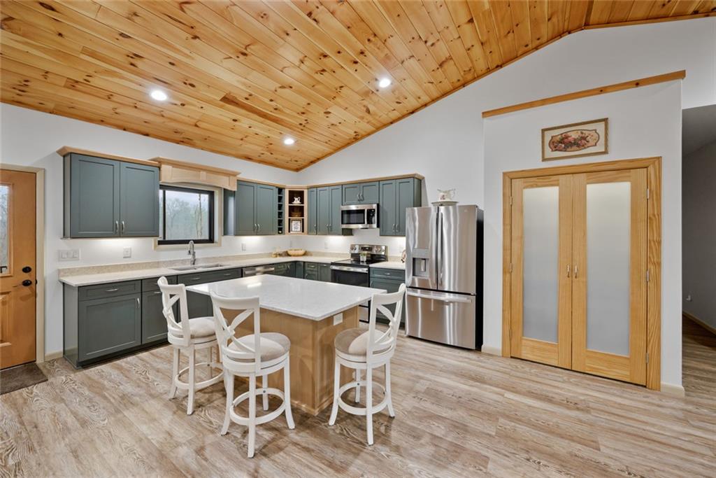 1581 Taylor Town Road Northeast Ranger, GA 30734 - Photo 3 of 37 a kitchen with a table chairs refrigerator and cabinets