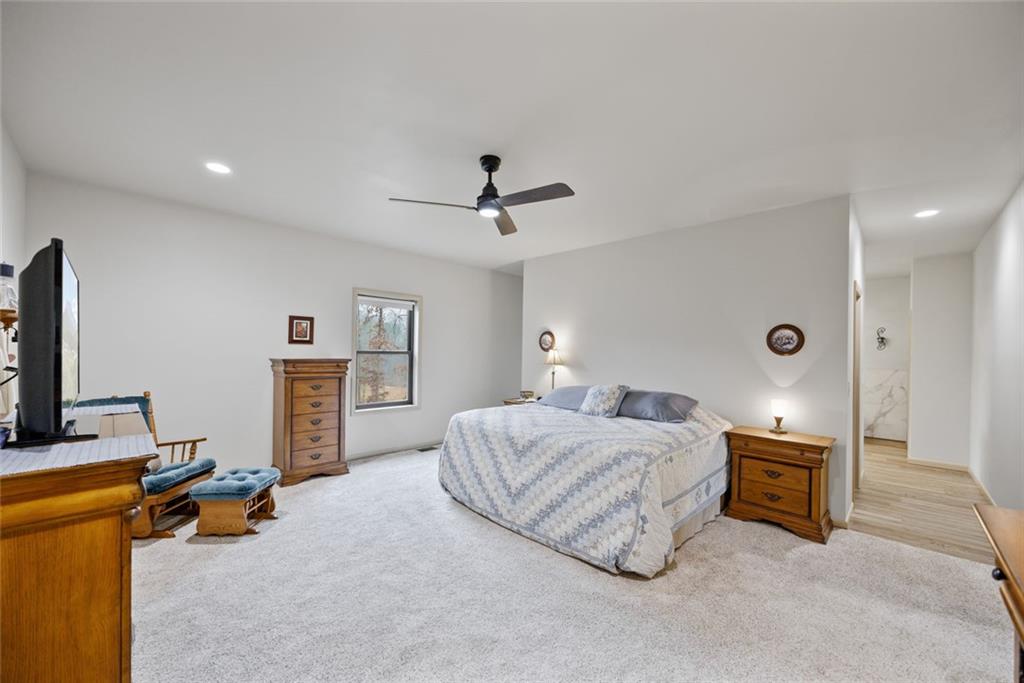 1581 Taylor Town Road Northeast Ranger, GA 30734 - Photo 9 of 30 a spacious bedroom with a bed a couch and a chandelier