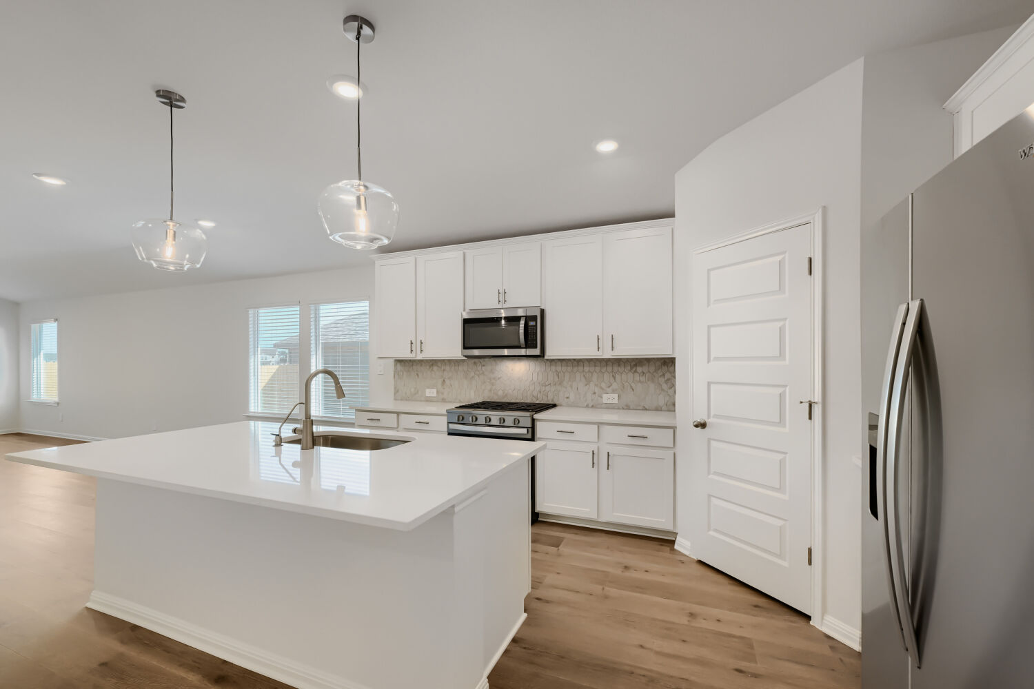 146 Diablo Rim Terrace Dripping Springs, TX 78620 - Photo 12 of 32 Culinary creations come to life in this kitchen, featuring an inviting island and essential appliances.