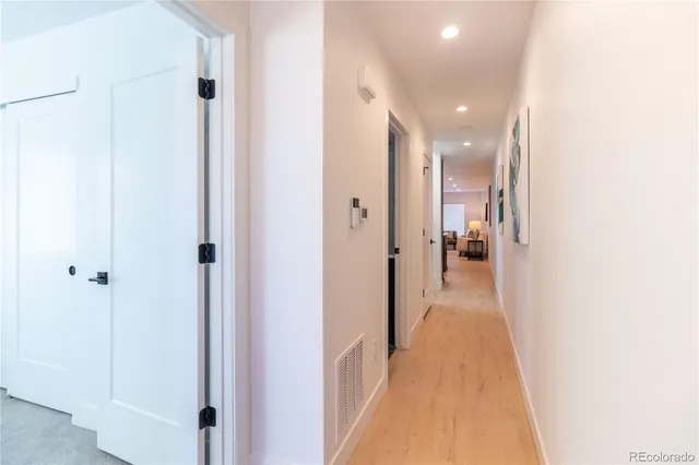 a view of a hallway with a white walls