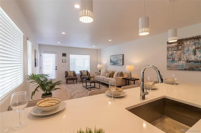 a living room with furniture flowerpot and a window