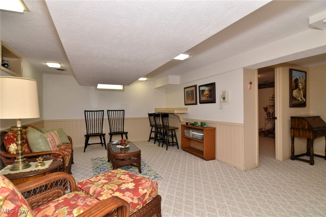 5510 Som Center Road Solon, OH 44139 - Photo 30 of 38 Living room with wainscoting, carpet floors, and a textured ceiling
