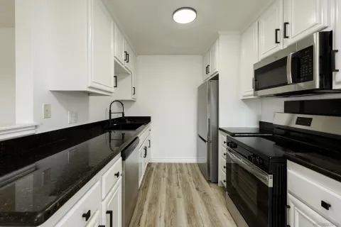 a kitchen with stainless steel appliances a sink stove and refrigerator