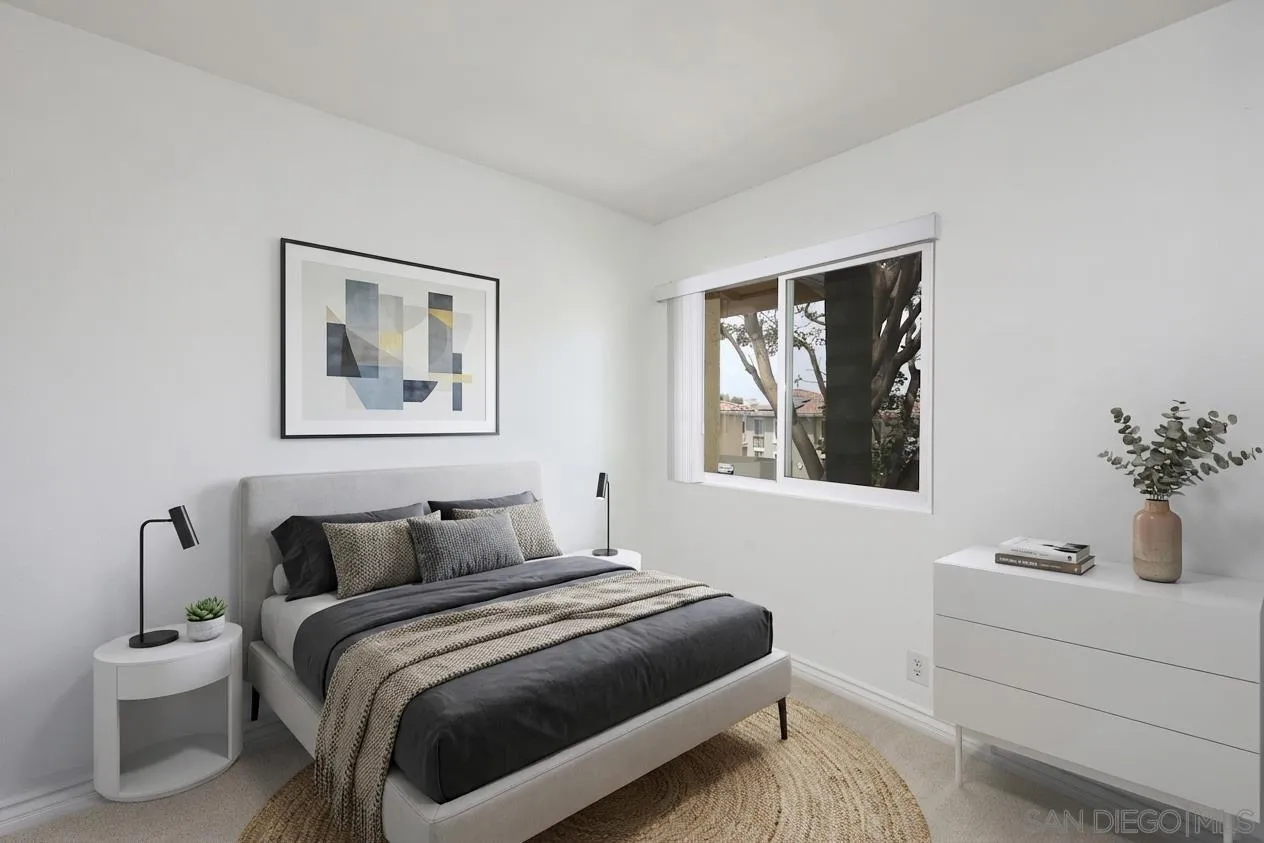 9949 Erma Road, Unit 203 San Diego, CA 92131 - Photo 29 of 43 a bedroom with a bed and a painting on the wall