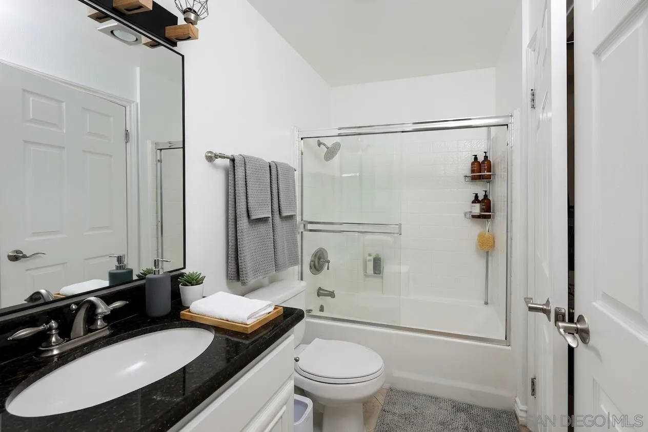 9949 Erma Road, Unit 203 San Diego, CA 92131 - Photo 32 of 43 a bathroom with a granite countertop sink toilet and shower