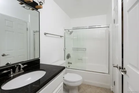a bathroom with a shower and mirror
