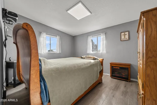 a bedroom with a bed and a mirror