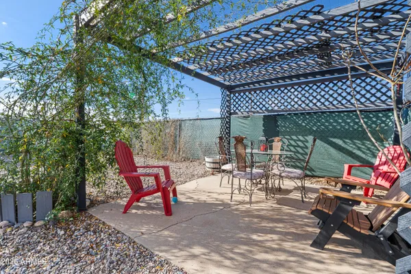 a view of a patio with table and chairs and potted plants