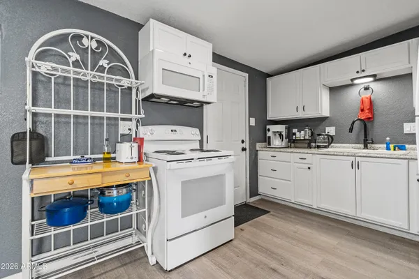 a kitchen with a stove a refrigerator and a sink