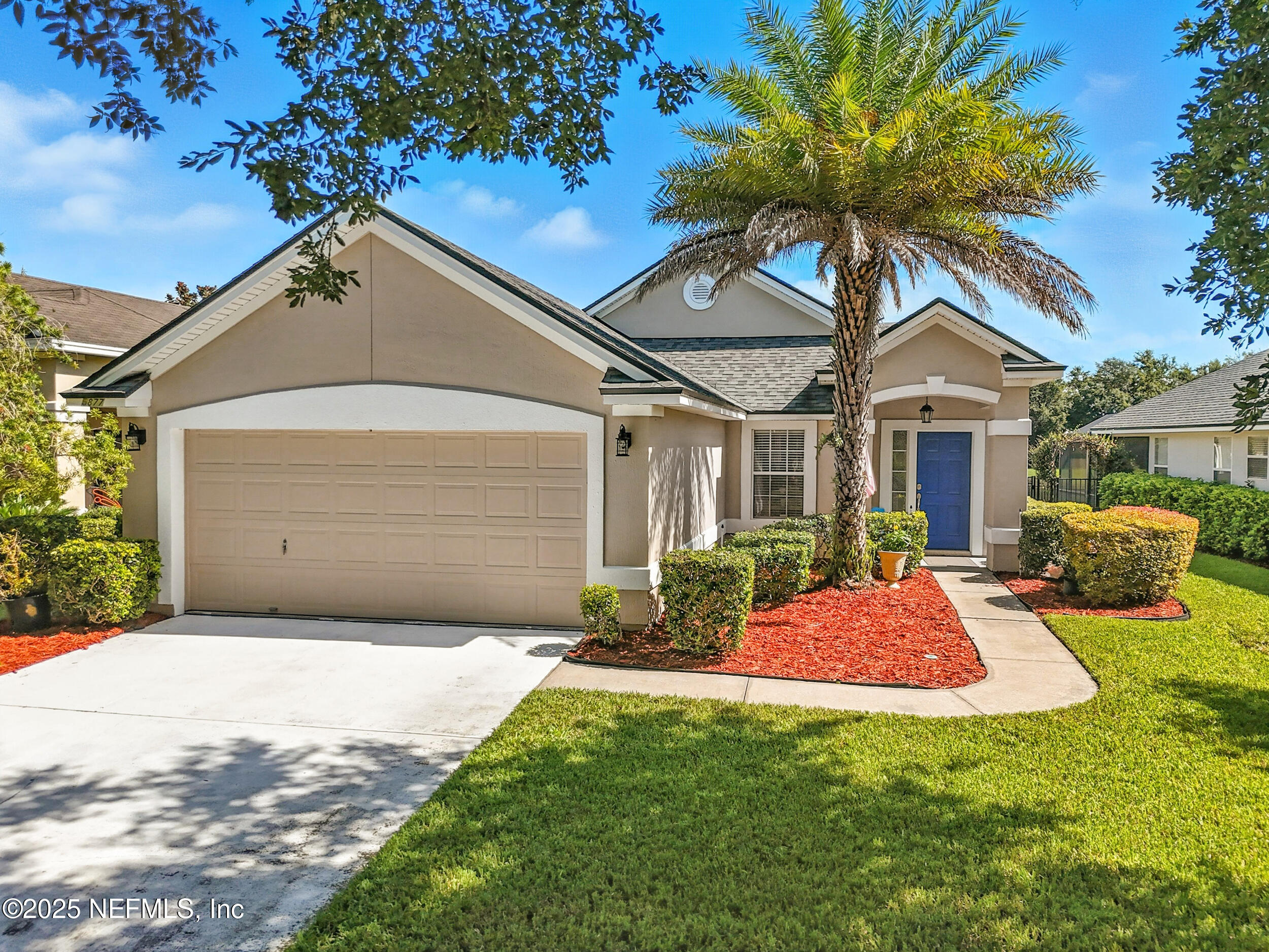 a front view of a house with yard patio and green space