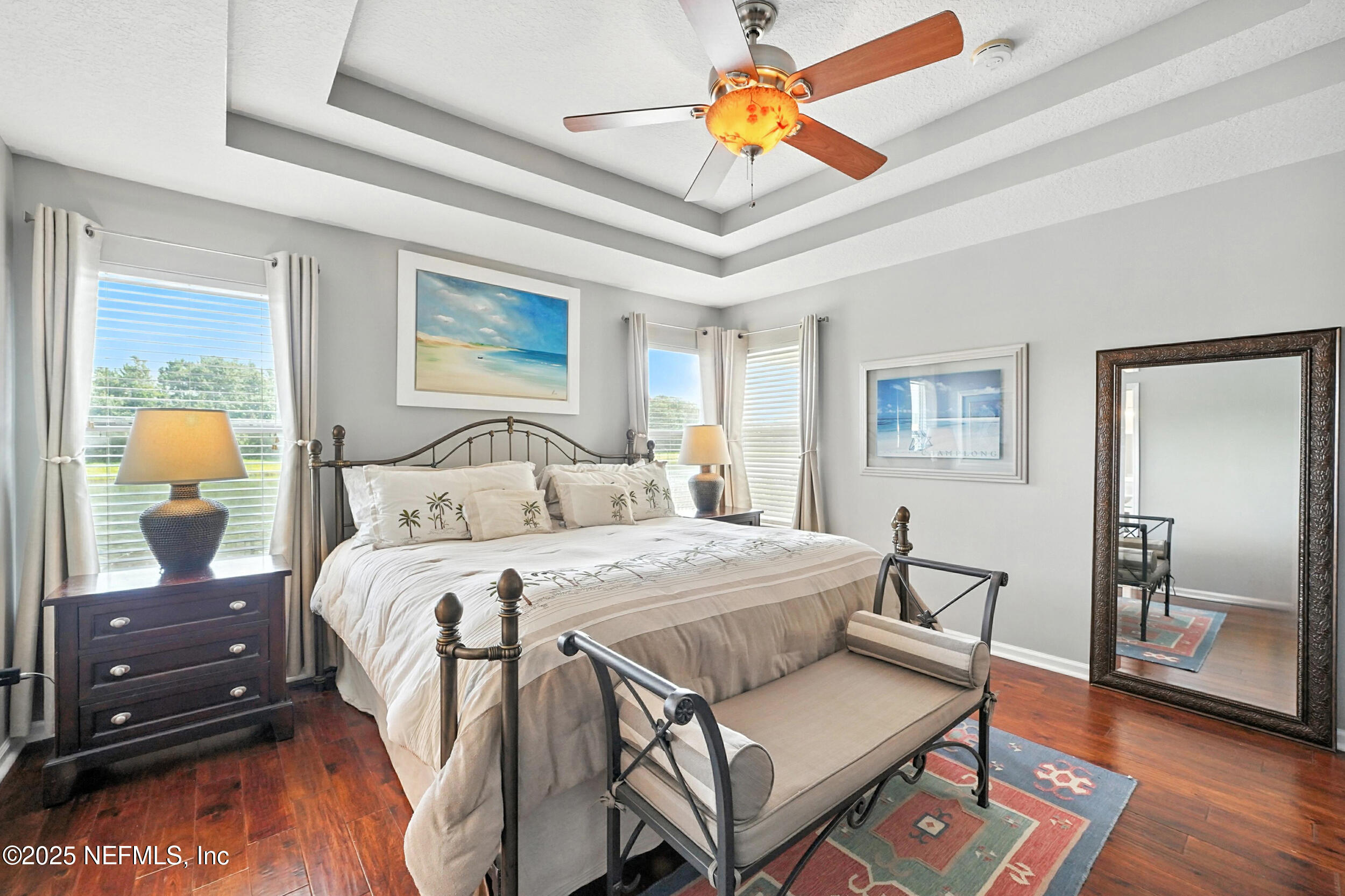 5877 Wind Cave Lane Jacksonville, FL 32258 - Photo 13 of 44 a bedroom with a bed and wooden floor