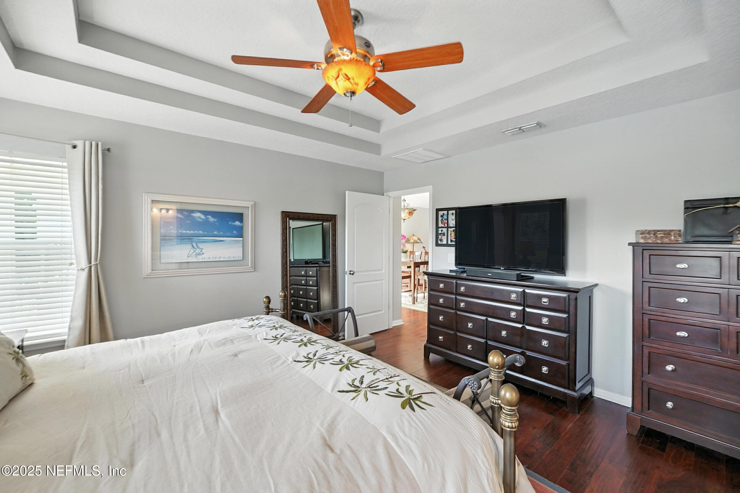5877 Wind Cave Lane Jacksonville, FL 32258 - Photo 14 of 44 a bedroom with a bed and a flat screen tv