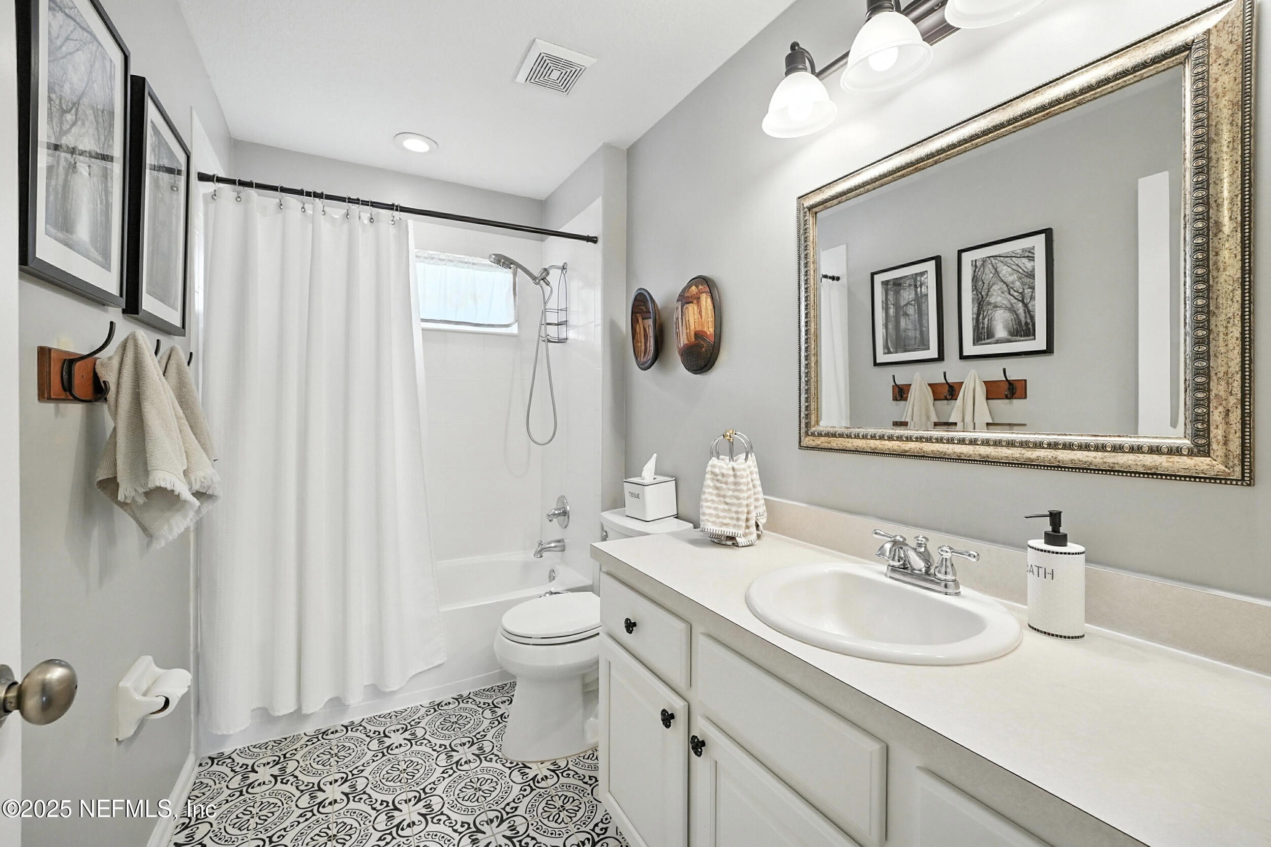 5877 Wind Cave Lane Jacksonville, FL 32258 - Photo 20 of 44 a bathroom with a double vanity sink mirror and toilet
