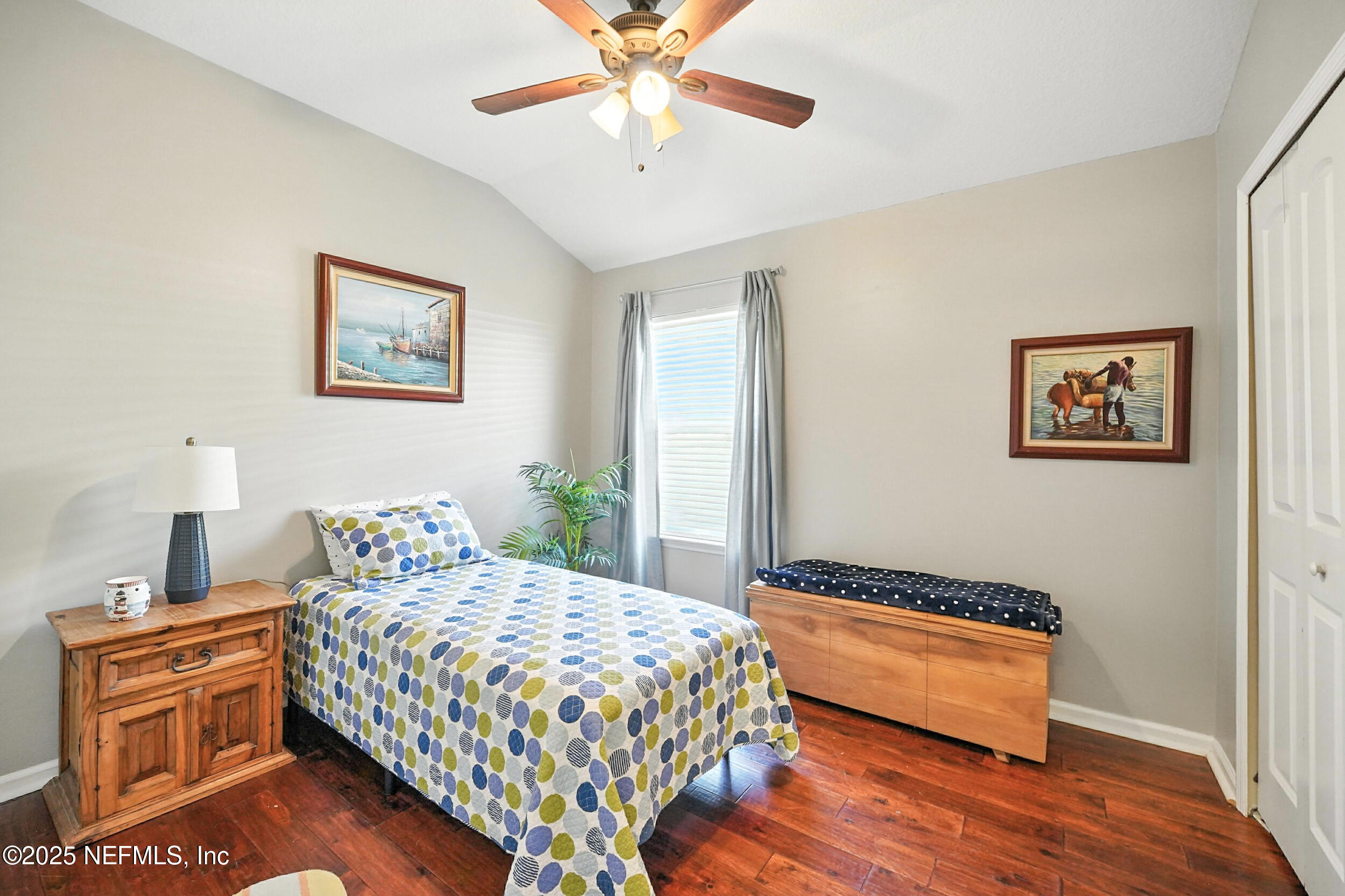 5877 Wind Cave Lane Jacksonville, FL 32258 - Photo 21 of 44 a bedroom with a bed and a chandelier