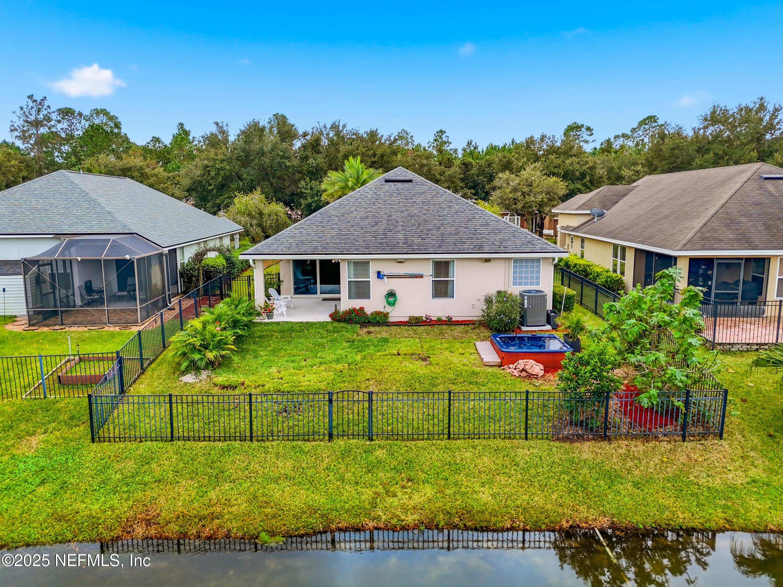 5877 Wind Cave Lane Jacksonville, FL 32258 - Photo 29 of 44 a view of a house with a big yard potted plants and large tree