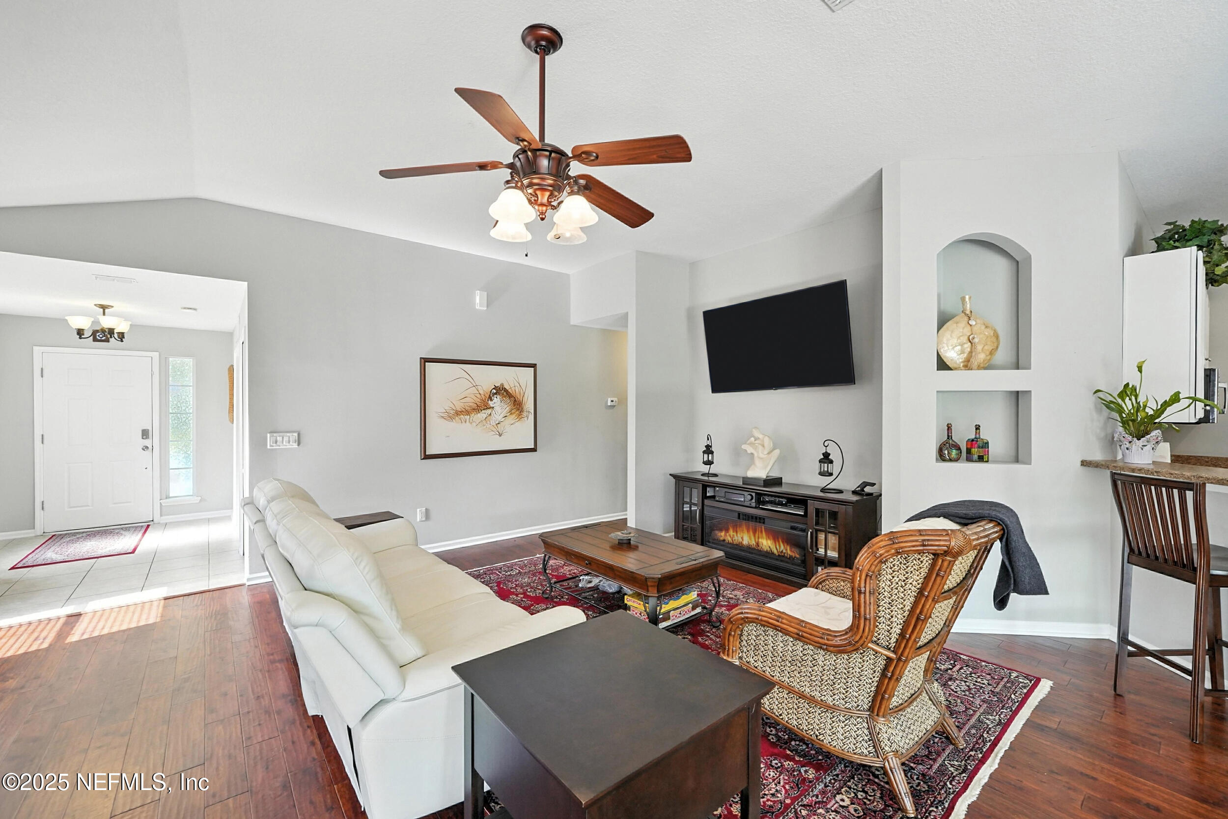5877 Wind Cave Lane Jacksonville, FL 32258 - Photo 4 of 44 a living room with furniture a flat screen tv and wooden floor