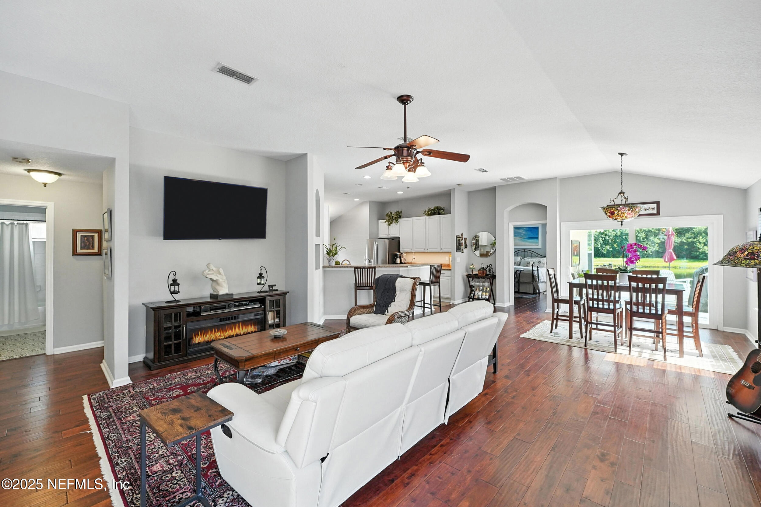 5877 Wind Cave Lane Jacksonville, FL 32258 - Photo 5 of 44 a living room with furniture and a flat screen tv