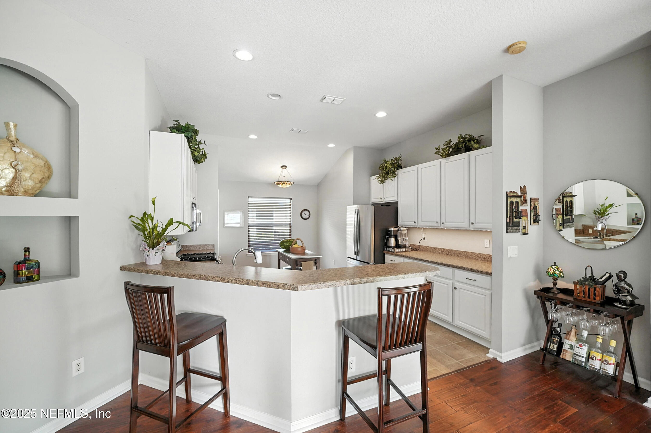 5877 Wind Cave Lane Jacksonville, FL 32258 - Photo 8 of 44 a kitchen with stainless steel appliances a table and chairs in it
