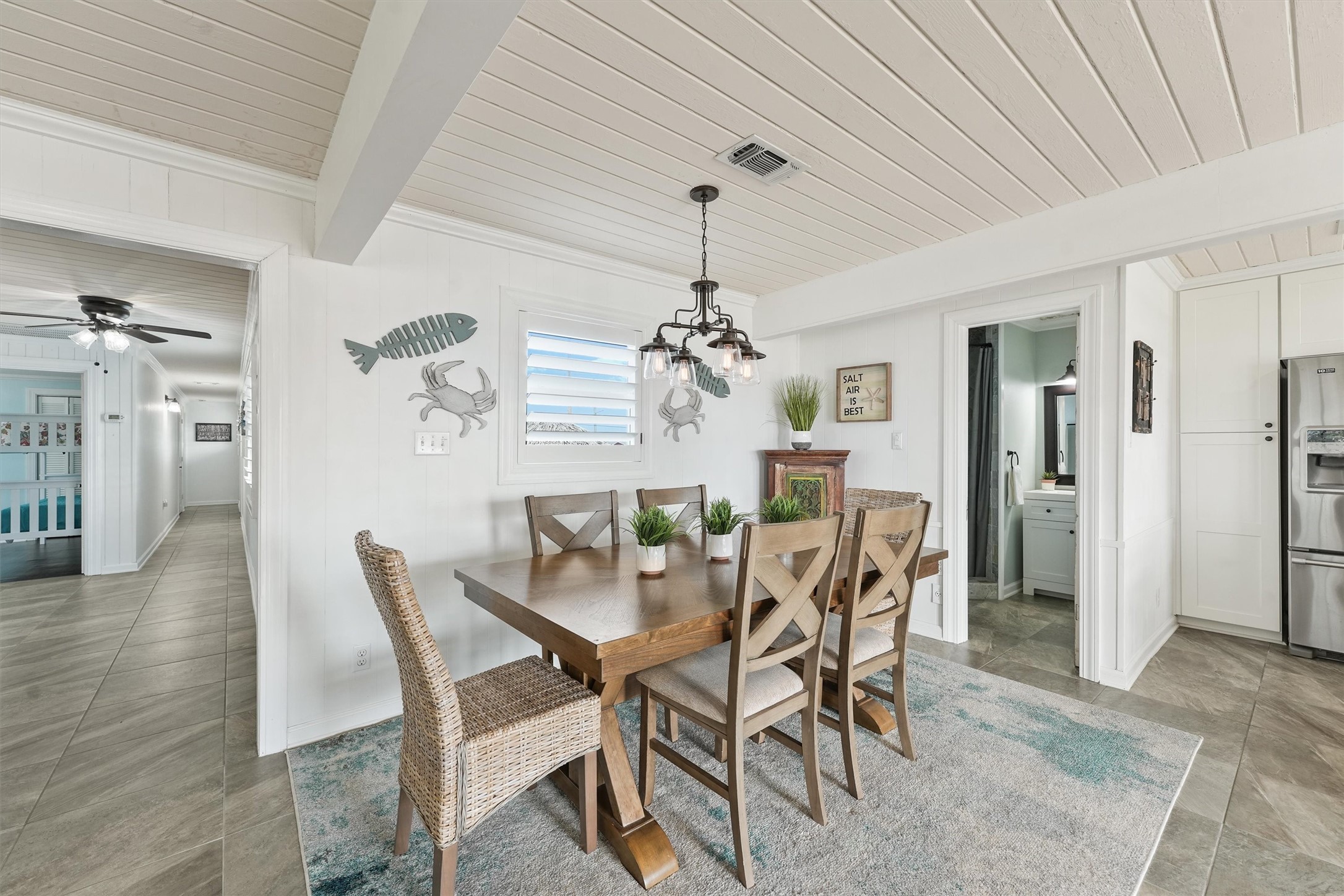 16634 Jamaica Beach Road Galveston, TX 77554 - Photo 15 of 47 a view of a dining room with furniture and chandelier