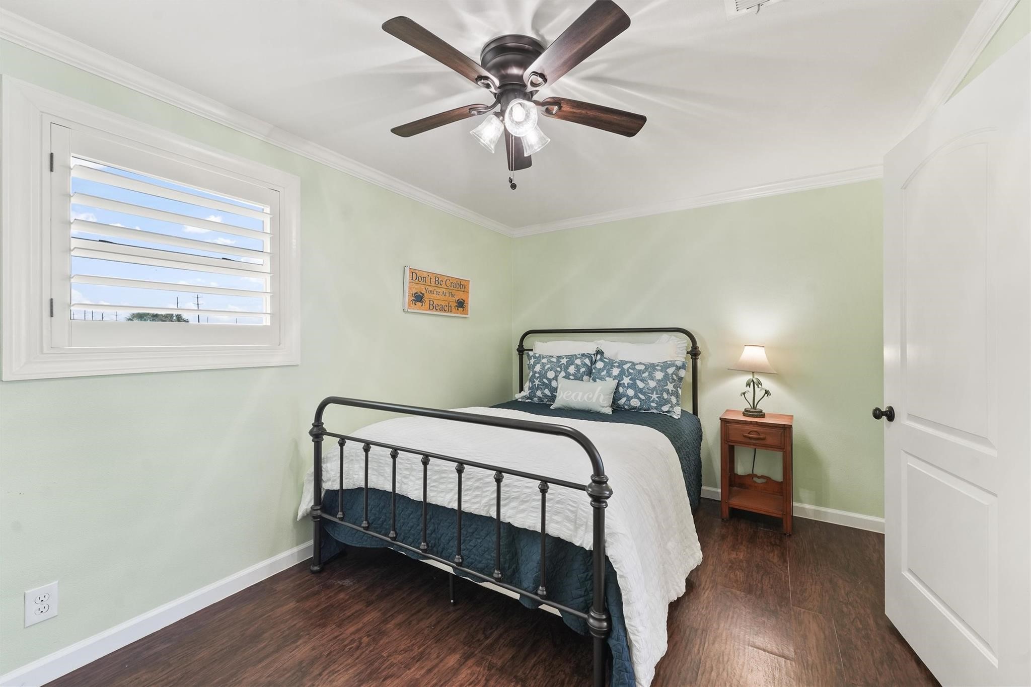 16634 Jamaica Beach Road Galveston, TX 77554 - Photo 23 of 47 a bedroom with a bed and a chandelier