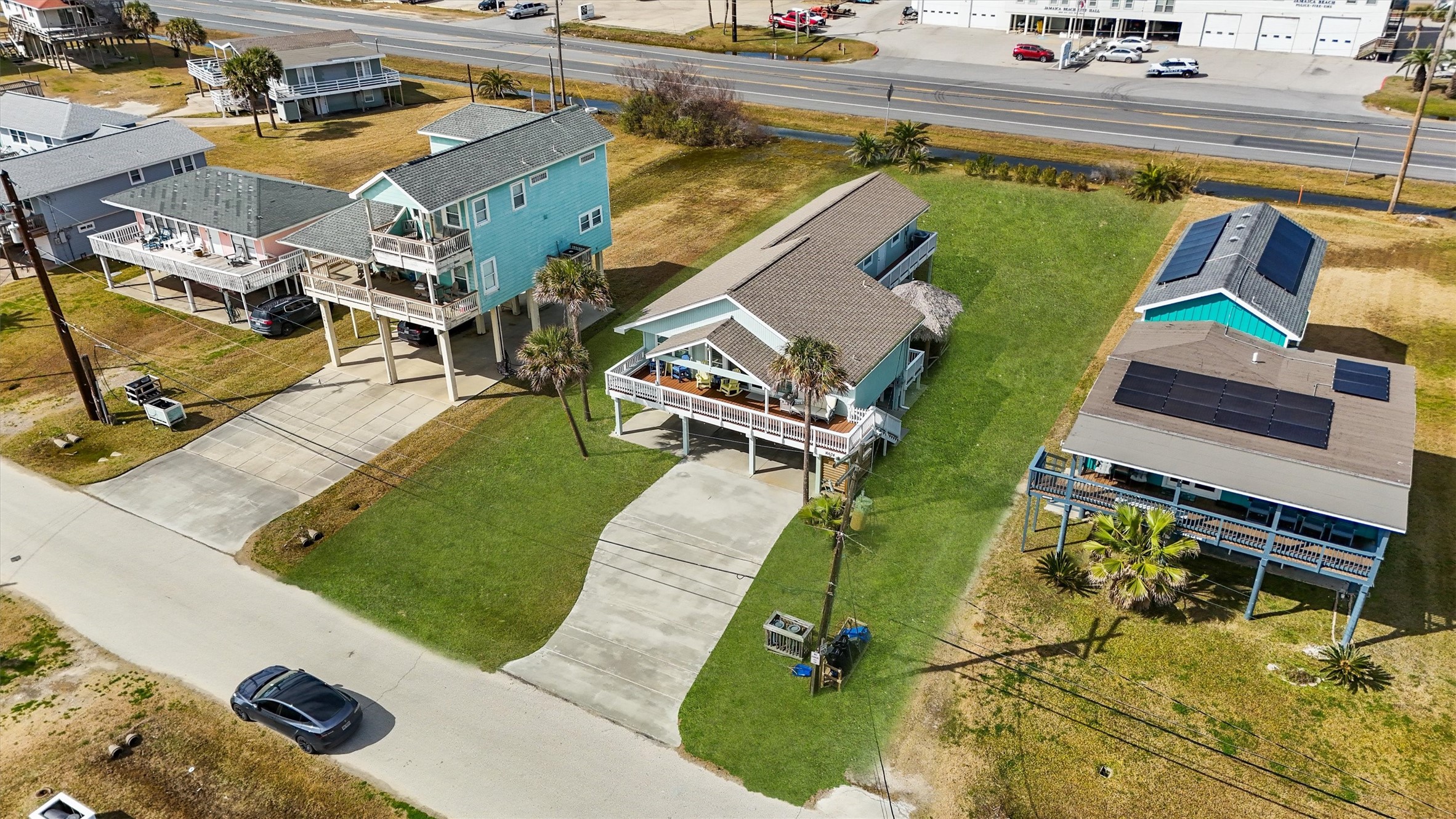 16634 Jamaica Beach Road Galveston, TX 77554 - Photo 34 of 47 an aerial view of a house with a garden and swimming pool