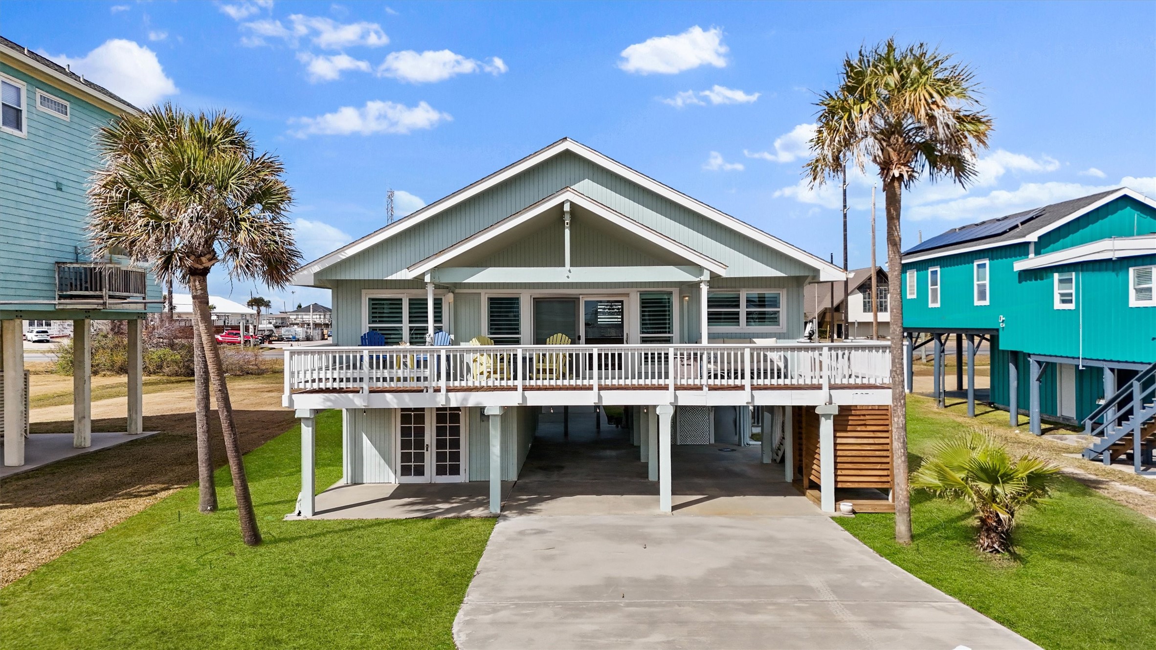 16634 Jamaica Beach Road Galveston, TX 77554 - Photo 39 of 47 a front view of a house with a yard table and chairs