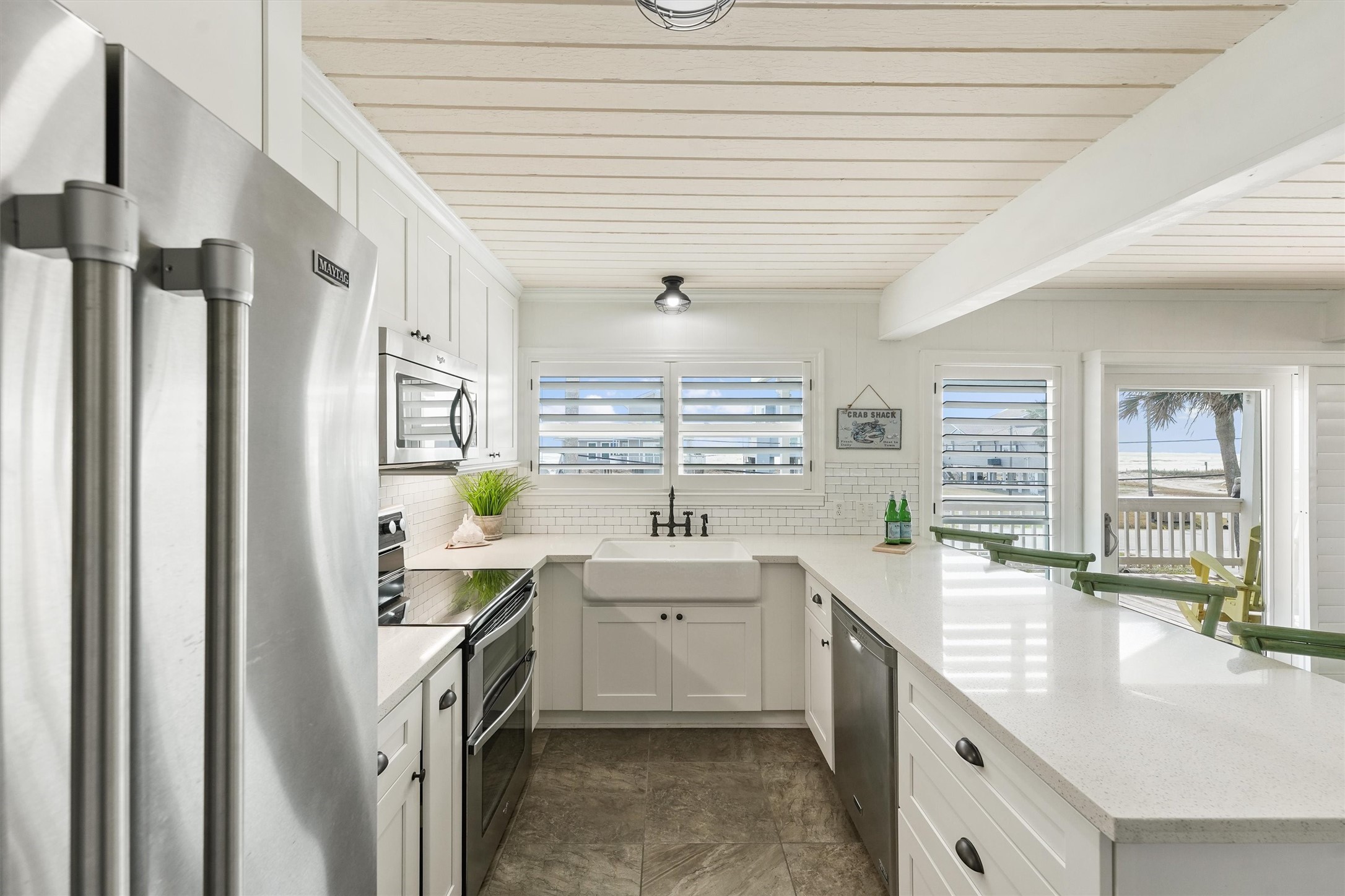16634 Jamaica Beach Road Galveston, TX 77554 - Photo 9 of 47 a bathroom with a double vanity sink a mirror and a bathtub