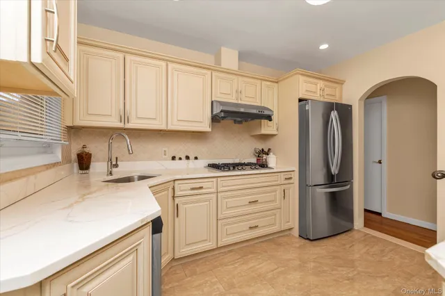 a kitchen with stainless steel appliances granite countertop a refrigerator sink and cabinets