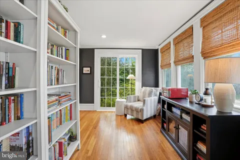 a dining room with a wooden table and chairs