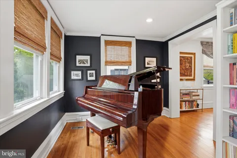 a dining room with furniture a chandelier and wooden floor