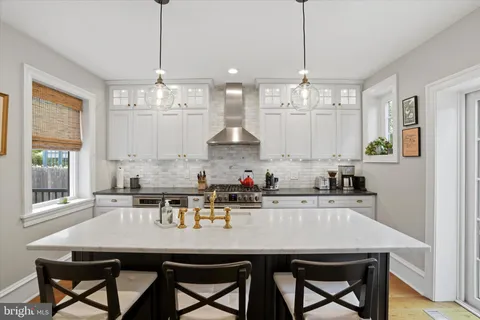 a kitchen with kitchen island a sink appliances and a counter top space