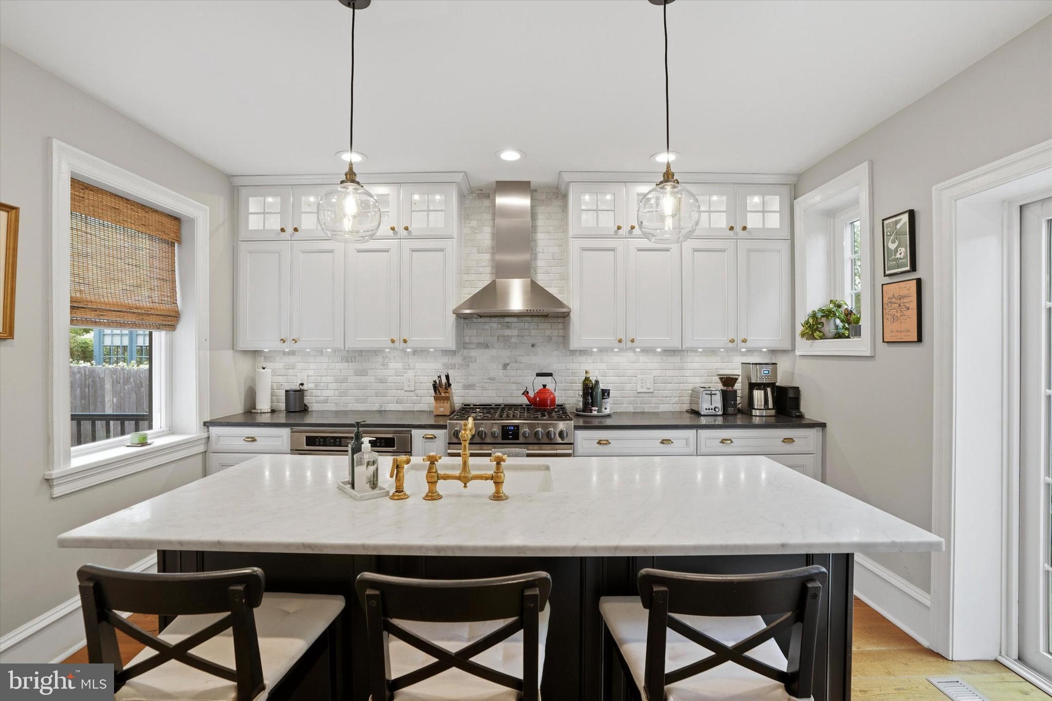 7 Farm Road Wayne, PA 19087 - Photo 20 of 65 a kitchen with stainless steel appliances a table and chairs in it