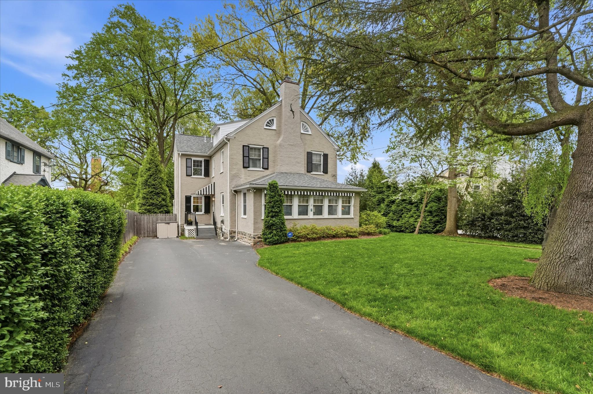 7 Farm Road Wayne, PA 19087 - Photo 2 of 65 a front view of a house with a garden and trees