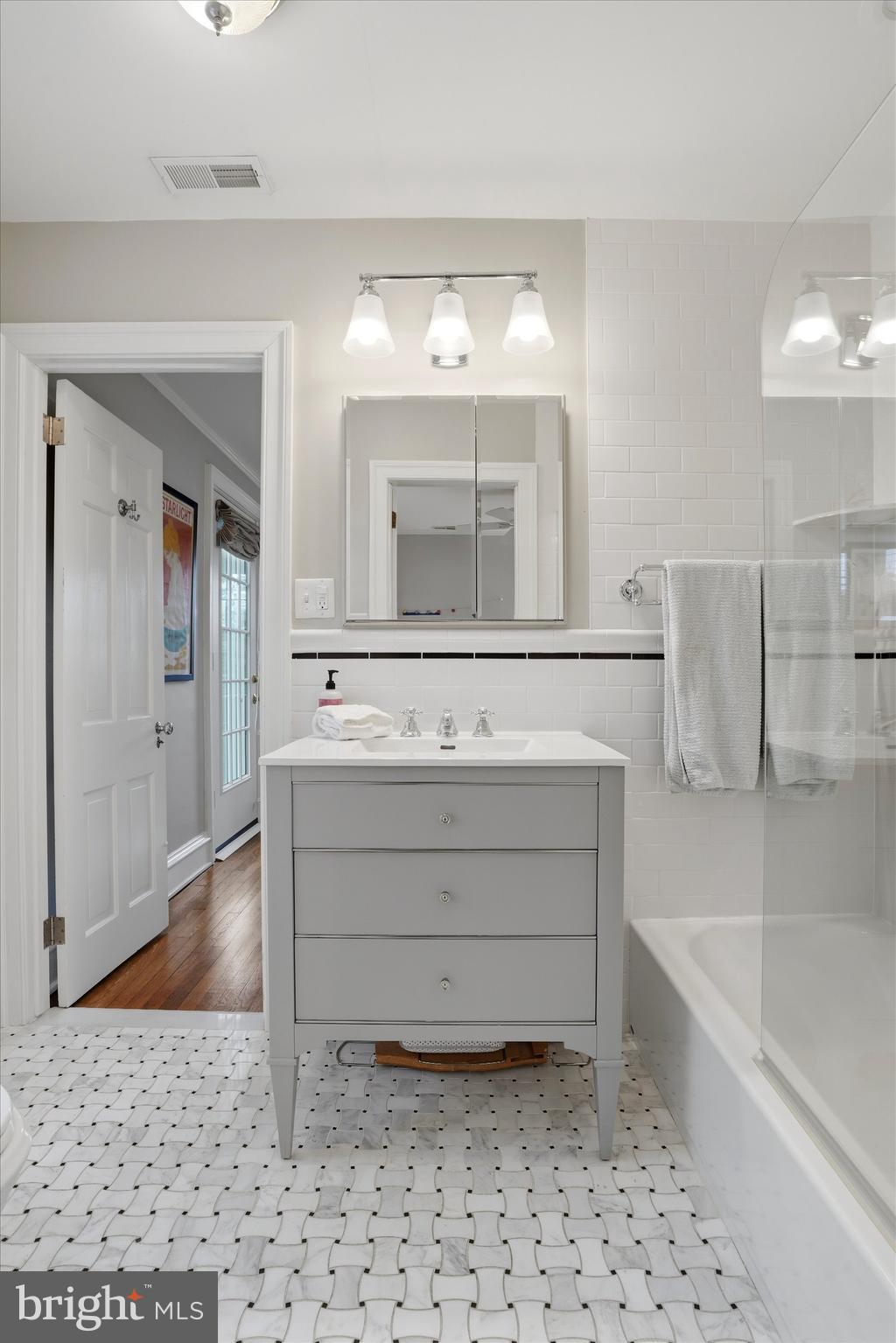 7 Farm Road Wayne, PA 19087 - Photo 27 of 65 a bathroom with a tub sink and a mirror