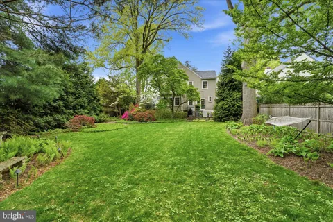 an aerial view of a house with a yard and garden