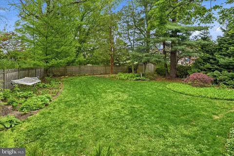 an aerial view of residential house with outdoor space and trees all around
