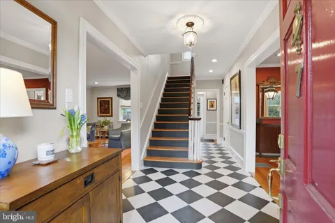 a view of entryway and hall with wooden floor