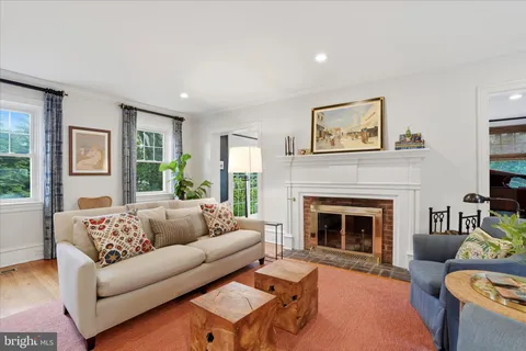a living room with furniture and a book shelf